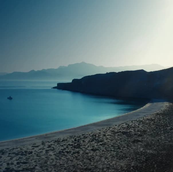 An image of a blue lagoon bay and sandy beach