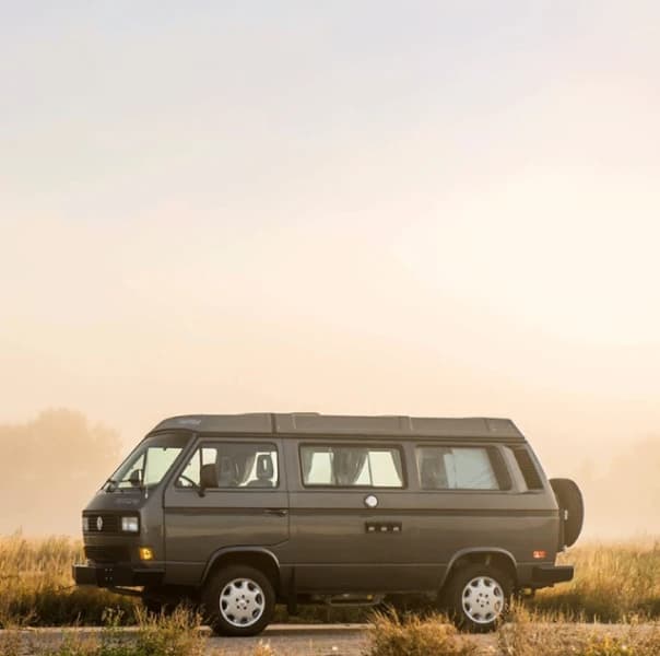 An image of a van on a road in a back country