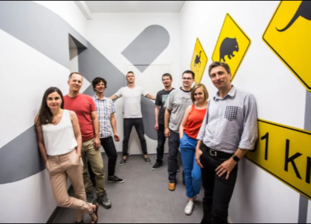 Members of the Xfive Team posing in the corridor of the company's office in Krakow