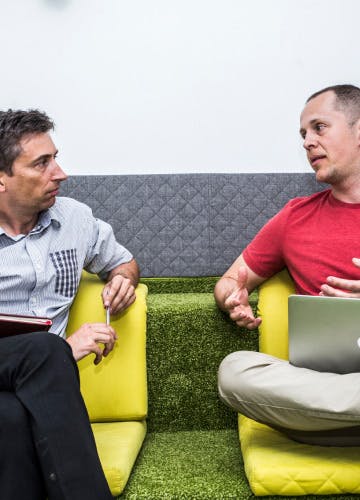 CEO Milosz Bazela and Chief of Products Department Stano Dzavoronok talk in the chill-out room at Xfive's office in Krakow.