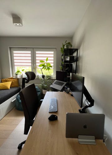 Home office: desk, screens, and laptop of one of Xfive Agency's remote employees.