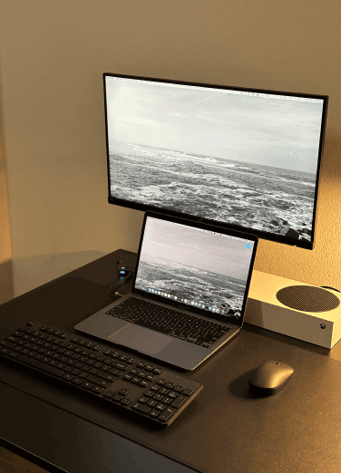 Home office: desk, screens, and a laptop of one of Xfive Agency's remote employees.