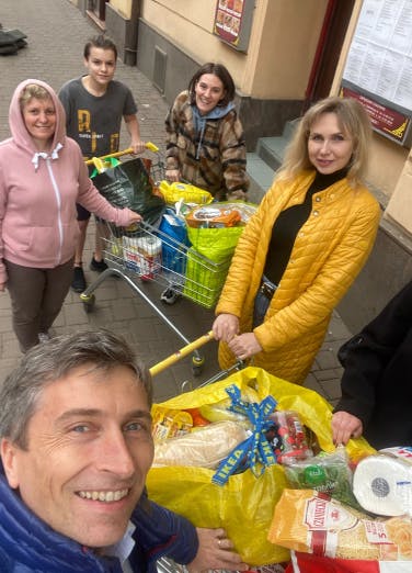 Xfive's CEO shopping with one of the Ukrainian families who found shelter in the company's office.