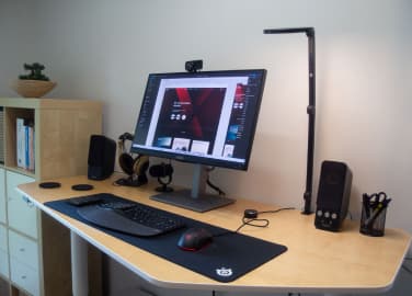 Home office: desk, screens, and a laptop of one of Xfive Agency's remote employees.