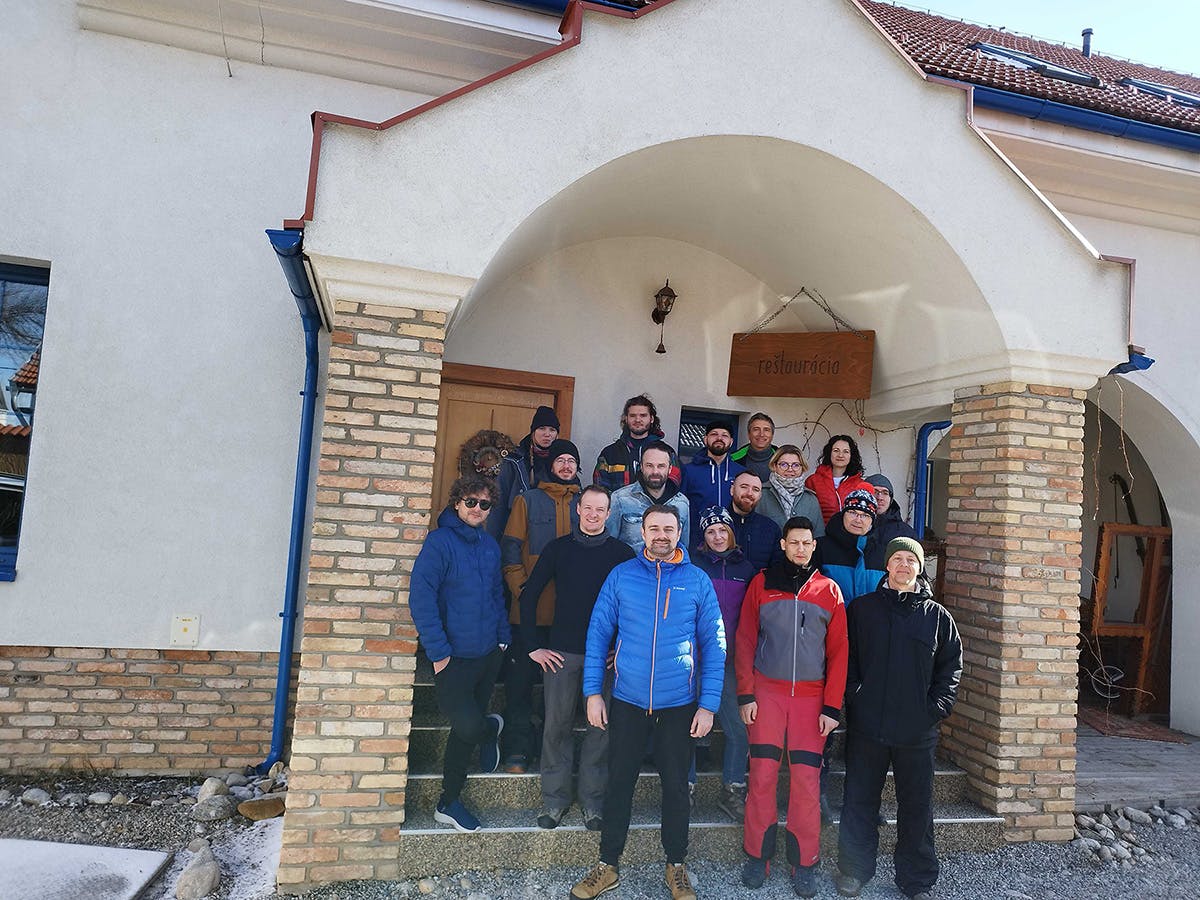A group photo of the Xfive team at the entrance to the guesthouse during the company's ski weekend.