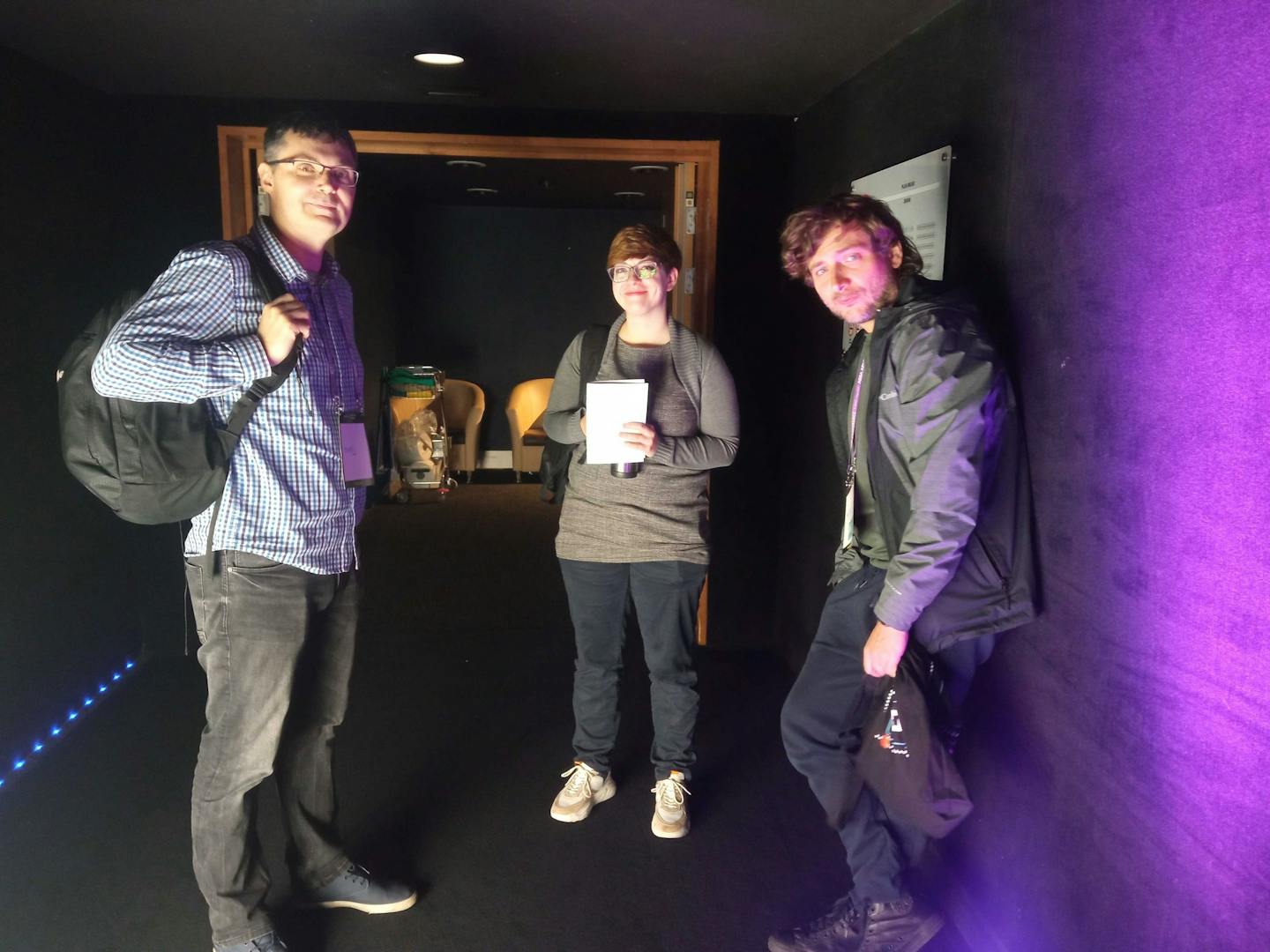 Three members of the Xfive team in a cinema.